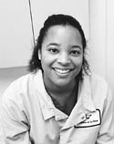 Holly Gonder smilling wearing a dental outfit