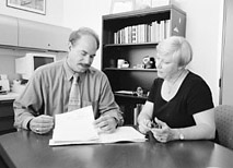 photo of Gammino and Blake reading over a file and confering